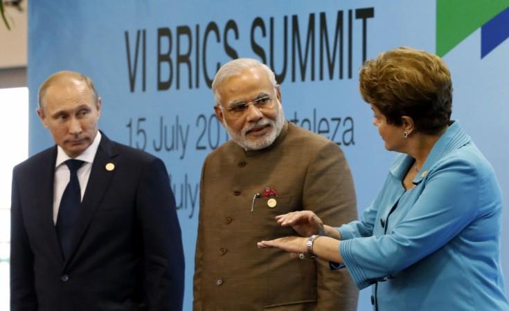 Brazil's President Rousseff talks to Russia's President Putin and India's Prime Minister Modi while they pose for a group picture during the VI BRICS Summit in Fortaleza