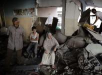 A Palestinian family gathers inside their damaged home, which police said was targeted in an Israeli air strike, in Gaza City.