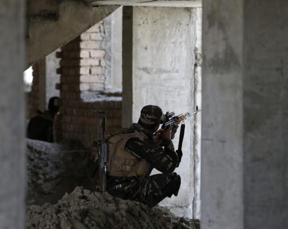 Afghan security personnel take position at the site of an attack, opposite a building where unidentified militants are located at, north of Kabul International Airport in Kabul Afghan security personnel take position at the site of an attack, opposite a building where unidentified militants are located at, north of Kabul International Airport in Kabul