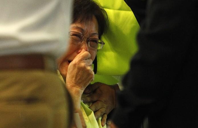 Malaysian Siti Dina weeps after seeing her daughter's name on the list of passengers on board Malaysia Airlines MH17 at Kuala Lumpur International Airport in Sepang. Malaysian Airline MH17 Crash