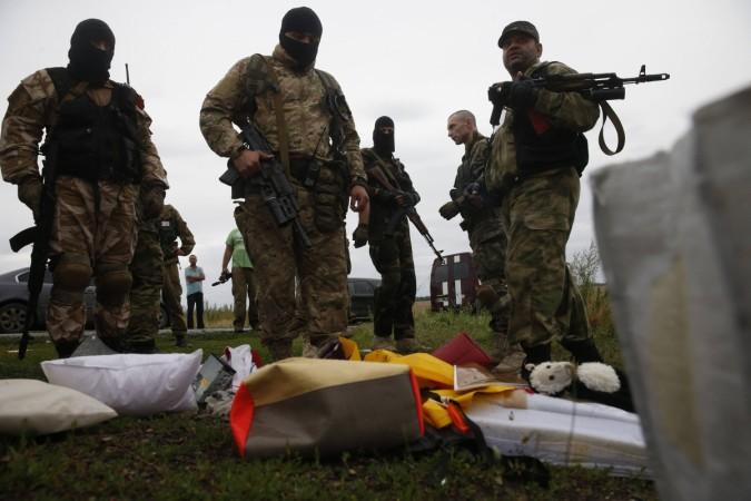 Pro-Russian separatists look at passengers' belongings at the crash site of Malaysia Airlines flight MH17, near the settlement of Grabovo in the Donetsk region Pro-Russian separatists look at passengers' belongings at the crash site of Malaysia Airlines flight MH17, near the settlement of Grabovo in the Donetsk region