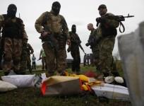 Pro-Russian separatists look at passengers' belongings at the crash site of Malaysia Airlines flight MH17, near the settlement of Grabovo in the Donetsk region