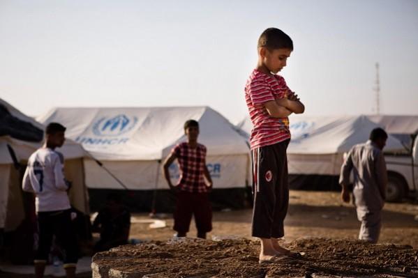 A boy, who fled from the violence in Mosul, stands near tents in a camp for internally displaced people on the outskirts of Arbil in Iraq's Kurdistan region. A boy, who fled from the violence in Mosul, stands near tents in a camp for internally displaced people on the outskirts of Arbil in Iraq's Kurdistan region
