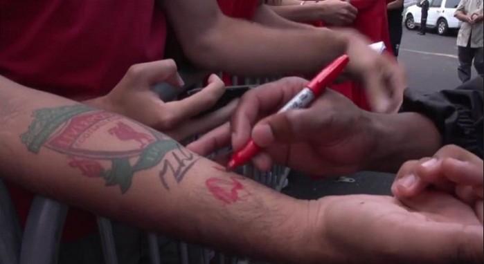 Liverpool striker Daniel Sturridge signs forearm that features Liverpool FC crest tattoo. Liverpool FC Tattoo