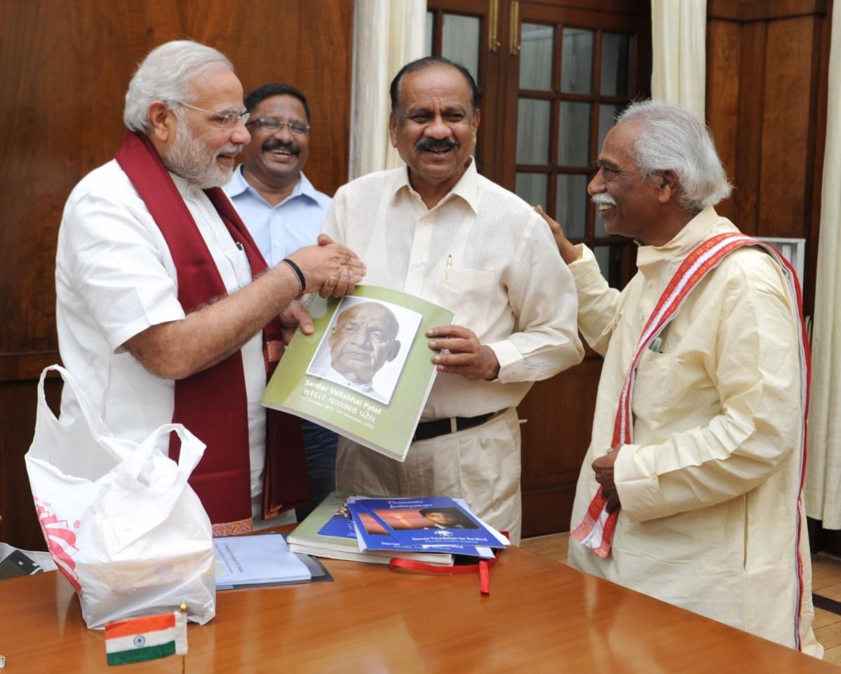 Naredra Modi releases A Saibaba Goud's transcript—Sardar Vallabhbhai Patel's biography in braille for the visually challenged—in the presence of MP Bandaru Dattatreya. Narendra Modi