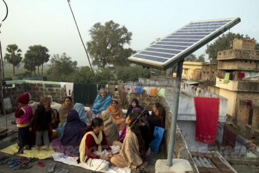 Local women of Dharnai sing on roof of a house where solar panels are installed Local women of Dharnai sing on roof of a house where solar panels are installed