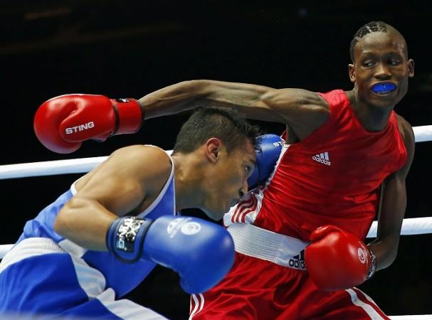 Mokhachane Moshoeshoe of Lesotho misses a punch at Manoj Kumar of India. Manoj Kumar
