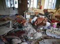 Palestinians collect the remains of bodies at a United Nation-run school sheltering Palestinians displaced by an Israeli ground offensive, that witnesses said was hit by Israeli shelling, in Jebalya refugee camp in the northern Gaza Strip