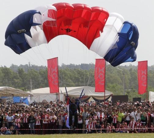 A skydiver lands with his tricolour parachute, depicting the Paraguayan flag, during a gathering of hundreds of students to celebrate the upcoming 200th anniversary of the country's independence, in Asuncion, 2011. Skydiving