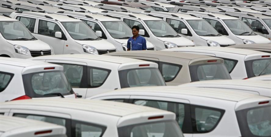 A worker walks at a Maruti Suzuki stockyard on the outskirts of the western Indian city of Ahmedabad July 28, 2012. Maruti Suzuki, India's biggest carmaker, lagged estimates with a 23 percent fall in fiscal first-quarter profit, its fourth consecutive qua