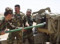 Kurdish Peshmerga troops prepare to fire a cannon during clashes with militants of the Islamic State in Iraq