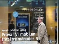 a-pedestrian-walks-past-a-telenor-store-in-central-stockholm
