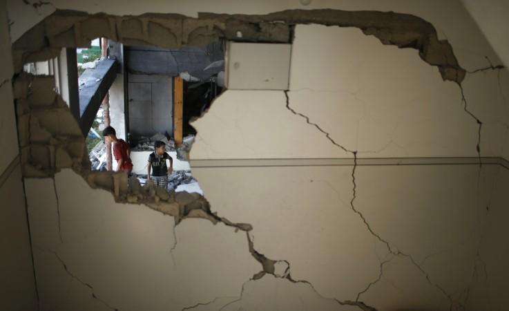 Palestinian boys look at a badly damaged mosque, which witnesses said was hit in an Israeli air strike, in Gaza City August 9, 2014. Palestinian boys look at a badly damaged mosque, which witnesses said was hit in an Israeli air strike, in Gaza City August 9, 2014.