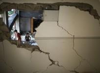 Palestinian boys look at a badly damaged mosque, which witnesses said was hit in an Israeli air strike, in Gaza City August 9, 2014.