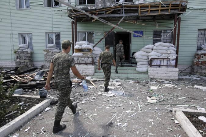 Ukrainian border guards walk into the headquarters of a local Ukrainian frontier guard detached unit, which according to Ukrainian servicemen, was attacked by weapons fired from the territory of Russia, in the town of Milove, in the Luhansk region August 8, 2014. Ukrainian border guards walk into the headquarters of a local Ukrainian frontier guard detached unit, which according to Ukrainian servicemen, was attacked by weapons fired from the territory of Russia, in the town of Milove, in the Luhansk region August