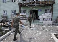 Ukrainian border guards walk into the headquarters of a local Ukrainian frontier guard detached unit, which according to Ukrainian servicemen, was attacked by weapons fired from the territory of Russia, in the town of Milove, in the Luhansk region August