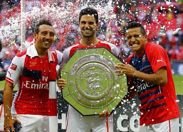 Arsenal players Santi Cazorla, Mikel Arteta and Alexis Sanchez celebrate with the Community Shield trophy Santi Cazorla Mikel Arteta Alexis Sanchez Arsenal