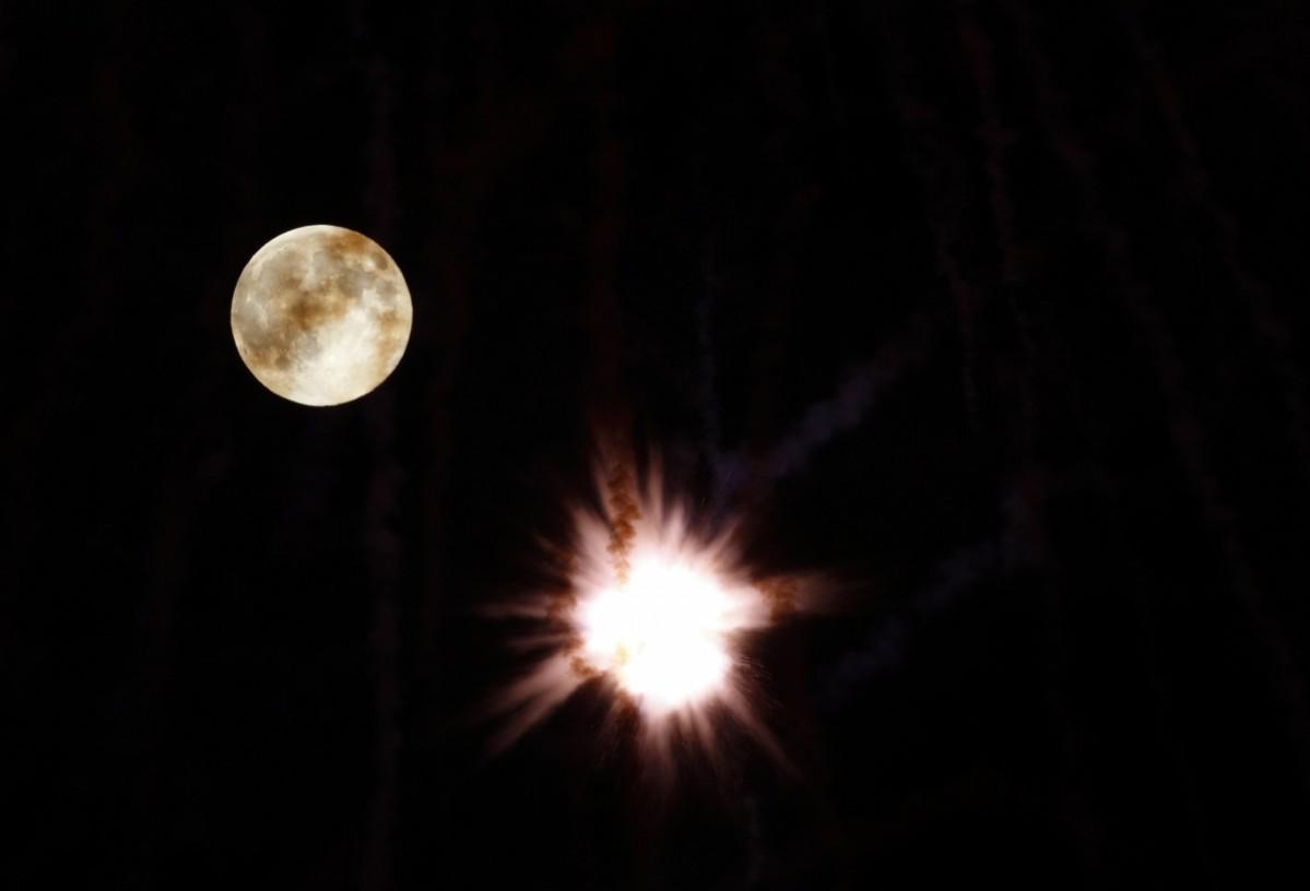A fireworks petard explodes in front of the supermoon outside the town of Mosta, celebrating the feast of its patron saint, in central Malta, August 10, 2014. A fireworks petard explodes in front of the supermoon outside the town of Mosta, celebrating the feast of its patron saint, in central Malta, August 10, 2014.