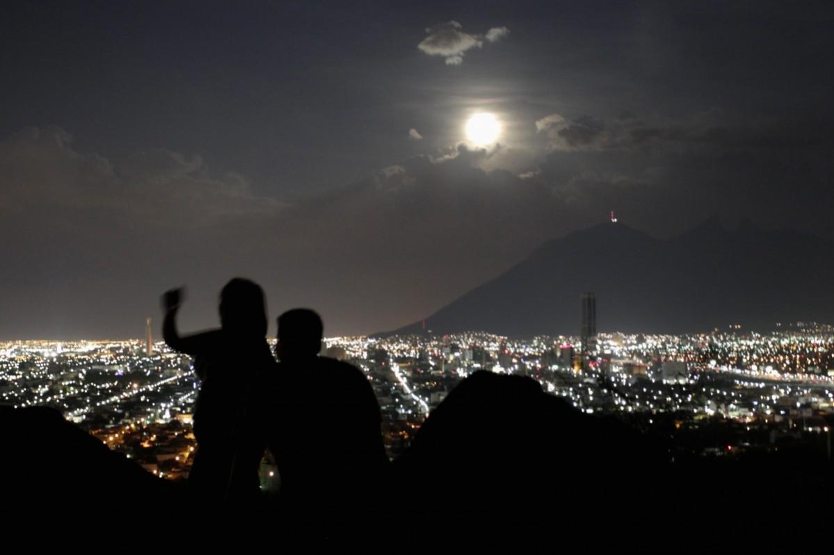 A supermoon rises while a couple takes a photo in Monterrey August 10, 2014. A supermoon rises while a couple takes a photo in Monterrey August 10, 2014.