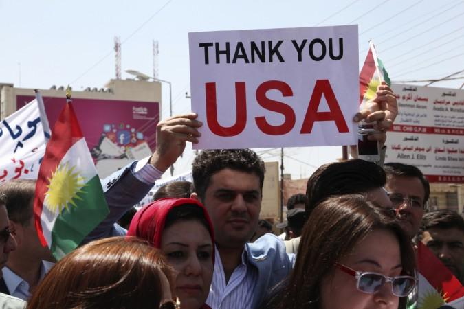 A Kurdish resident holds a signs during a demonstration in support of the Peshmerga troops in front of the U.S. consulate in Arbil, north of Baghdad, A Kurdish resident holds a signs during a demonstration in support of the Peshmerga troops in front of the U.S. consulate in Arbil, north of Baghdad,