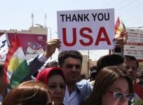 A Kurdish resident holds a signs during a demonstration in support of the Peshmerga troops in front of the U.S. consulate in Arbil, north of Baghdad,