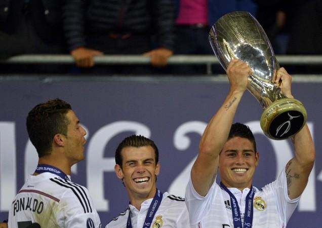 James Rodriguez lifts the UEFA Super Cup trophy as Gareth Bale and Cristiano Ronaldo look on Cristiano Ronaldo Gareth Bale James Rodriguez Real Madrid