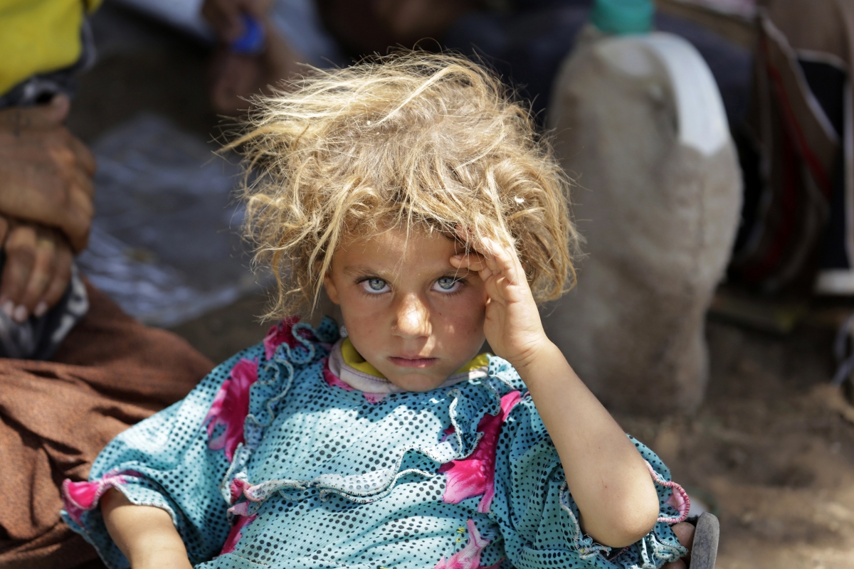 A child from the minority Yazidi sect, fleeing the violence in the Iraqi town of Sinjar, rests at the Iraqi-Syrian border crossing in Fishkhabour, Dohuk province.