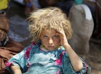 A child from the minority Yazidi sect, fleeing the violence in the Iraqi town of Sinjar, rests at the Iraqi-Syrian border crossing in Fishkhabour, Dohuk province.