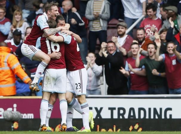 Stewart Downing (R) of West Ham United is mobbed by team mates as he celebrates scoring against Tottenham Hotspur during their English Premier League soccer match. West Ham United