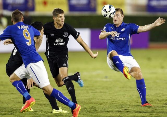 Leicester City's Christopher Wood (R) fights for the ball against Everton's John Stones (C) during a friendly soccer match. Leicester City and Everton