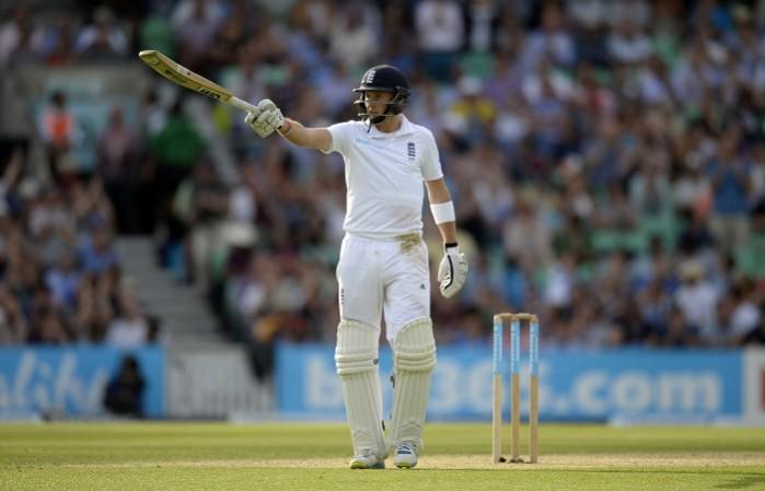 Joe Root raises his bat after completing his half-century Joe Root England