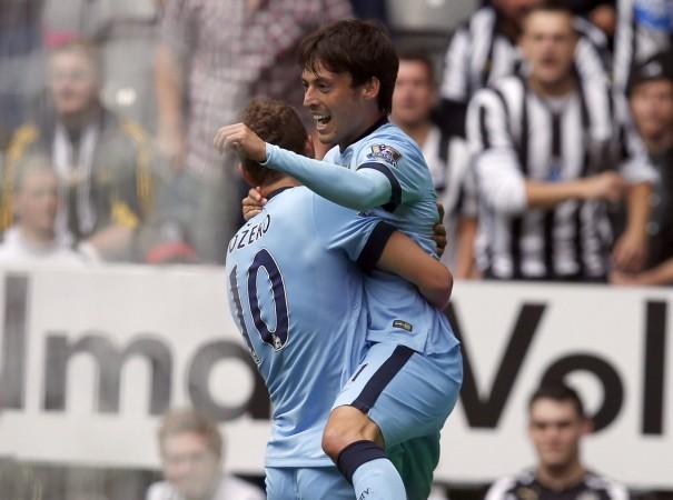 Manchester City's David Silva (R) celebrates with teammate Edin Dzeko after scoring a goal against Newcastle United during their English Premier League match at St James' Park Newcastle United vs Manchester City