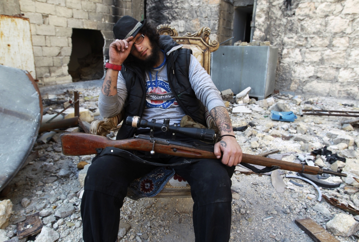 Aleppo, Syria
Khattab al-Halabi, a former tattoo artist who is now a Free Syrian Army fighter, poses with his weapon at the Karm al-Jabal frontline in Aleppo February 23, 2014. Picture taken February 23, 2014. World Photography day