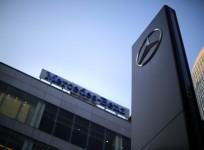 A Mercedes-Benz logo and sign are seen at a dealership