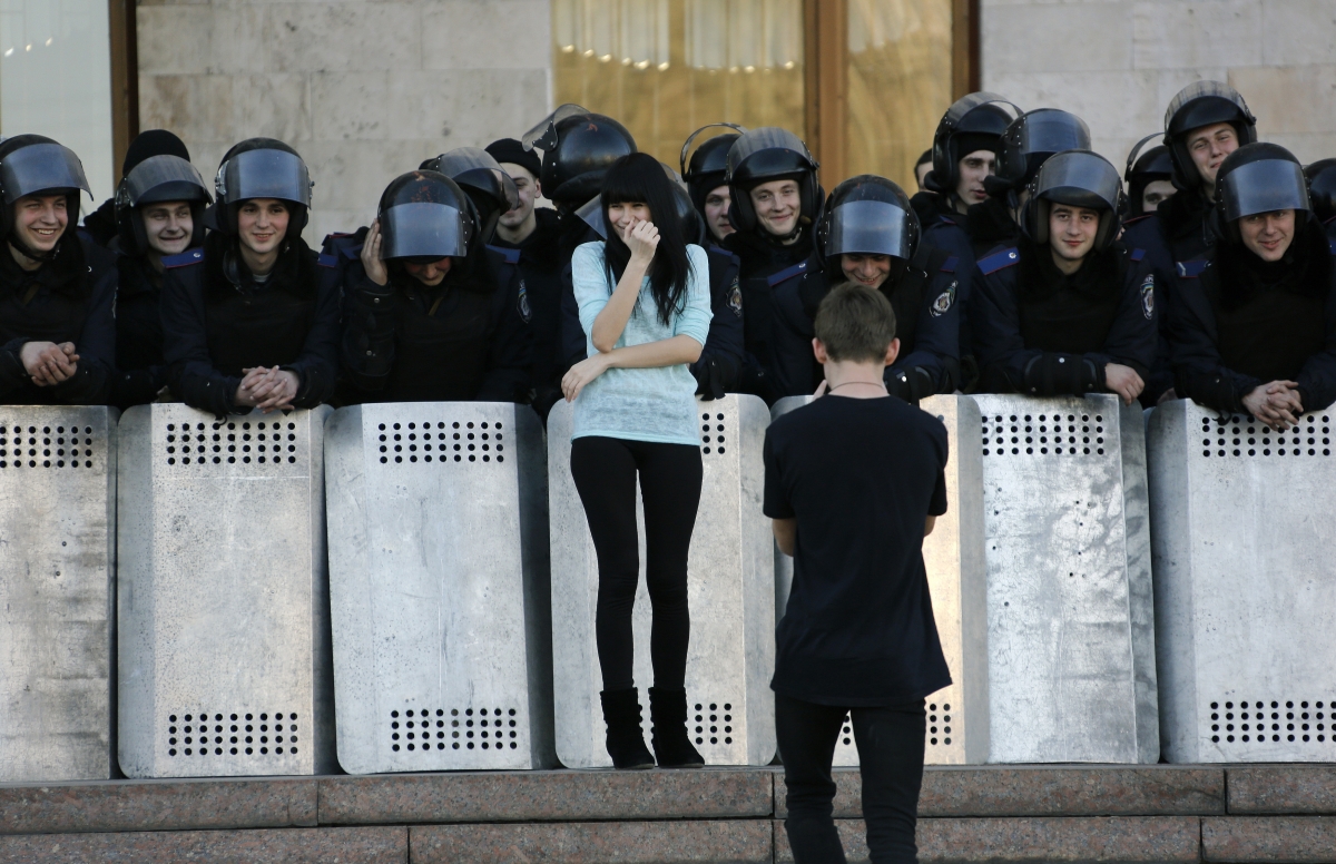 Donetsk, Ukraine
A young man takes photos of his girlfriend next to Ukrainian riot policemen guarding the regional administration building following a pro-Russian rally in central Donetsk March 23, 2014. Several thousands of pro-Russian protesters marched from Lenin square to the regional administration building calling for the return of the pro-Moscow President Yanukovich. World Photography day