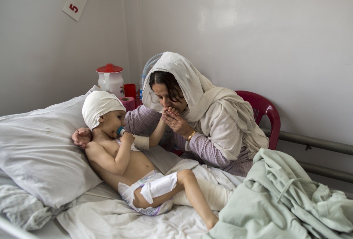 Kabul, Afghanistan
Abuzar, the son of Afghan journalist Sardar Ahmed of Agence France-Presse (AFP) who was killed with his wife and two children during an attack by gunmen at Serena Hotel, is comforted by his grandmother at the Emergency hospital in Kabul March 27, 2014. The two-year-old, his head heavily bandaged, has emerged from a coma, and the sight of him chuckling during hospital visits from his aunt give doctors hope he can make a full recovery. He may now go to Canada to live with an uncle. Picture taken March 27, 2014. World Photography day