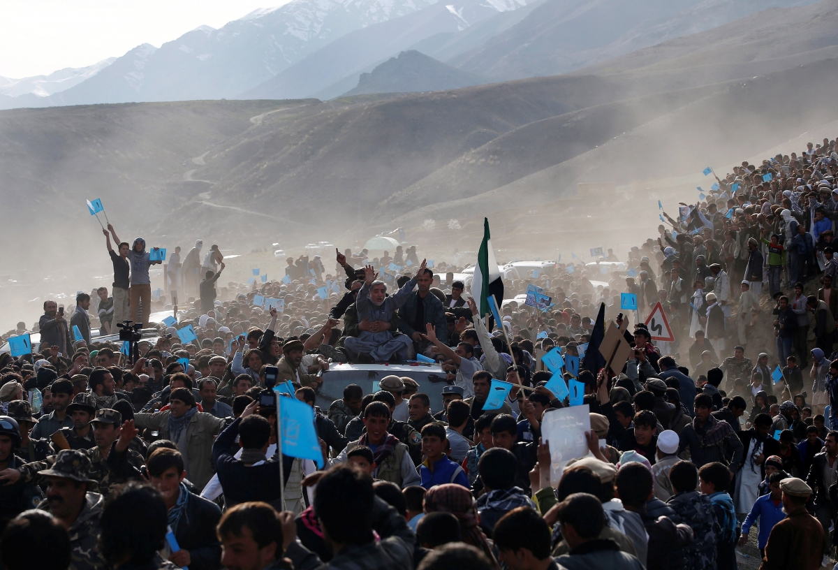 Panjshir, Afghanistan
Presidential candidate Abdullah Abdullah (in grey), sitting atop a vehicle, arrives for an election campaign in Panjshir province March 31, 2014. The Afghan presidential election will be held on April 5. World Photography day