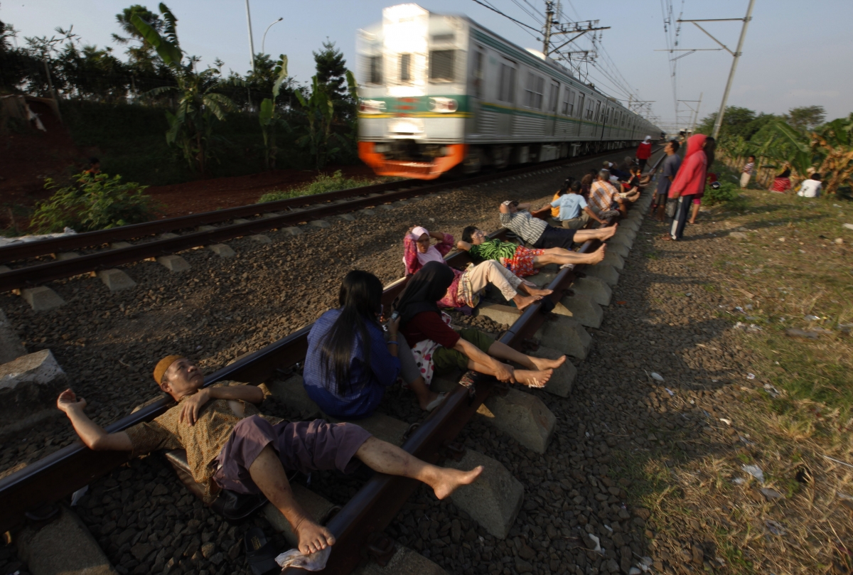 Lying down on railway tracks