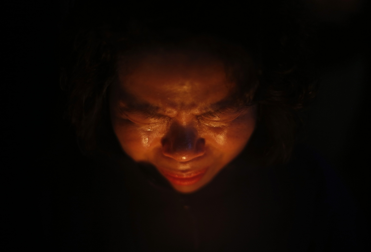 Ansan, South Korea
A woman cries while praying during a candlelight vigil in Ansan, to commemorate the victims of capsized passenger ship Sewol and to wish for the safe return of missing passengers, April 23, 2014. South Korean divers swam though dark, cold waters into the sunken ferry on Wednesday, feeling for children's bodies with their hands in a maze of cabins, corridors and upturned decks as they searched for hundreds of missing. The Sewol sank last Wednesday on a routine trip from the port of Incheon, near Seoul, to the southern island of Jeju. World Photography day