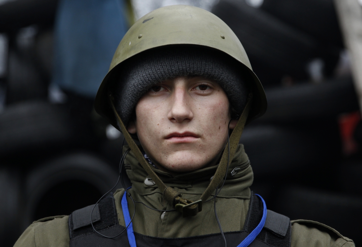 Ukraine
Anatoli, a 19-year-old student from the town of Dnepropetrovsk, poses for a picture at the barricades in Kiev February 10, 2014. World Photography day
