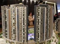 A potential buyer looks at a model of Riva, one of the latest developments by Sun Hung Kai Properties, in Hong Kong