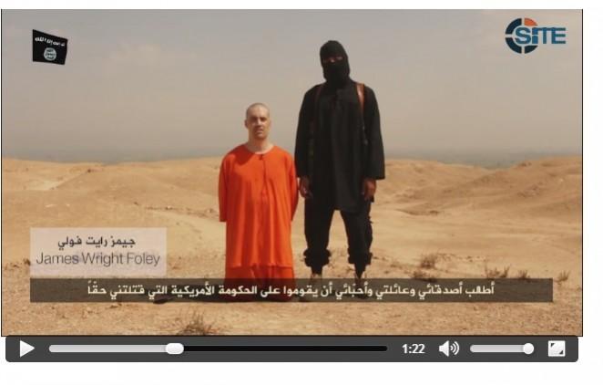 This screenshot of the video released by the Islamic State shows US photojournalist James Foley along with his executioner. IS beheads US journalist