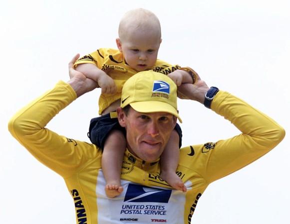 Lance Armstrong of the USA celebrates his Tour de France victory with his 9 month-old son Luke in July 2000. Lance Armstrong