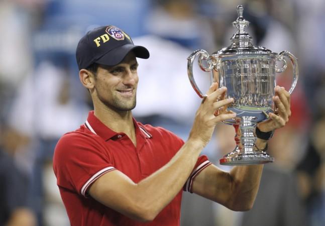 Novak Djokovic of Serbia holds up his trophy after defeating Rafael Nadal of Spain in the men's final of the US Open tennis tournament in New York, September 12, 2011. Novak Djokovic