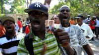 aristide-supporters-rally-at-his-home-to-prevent-his-arrest