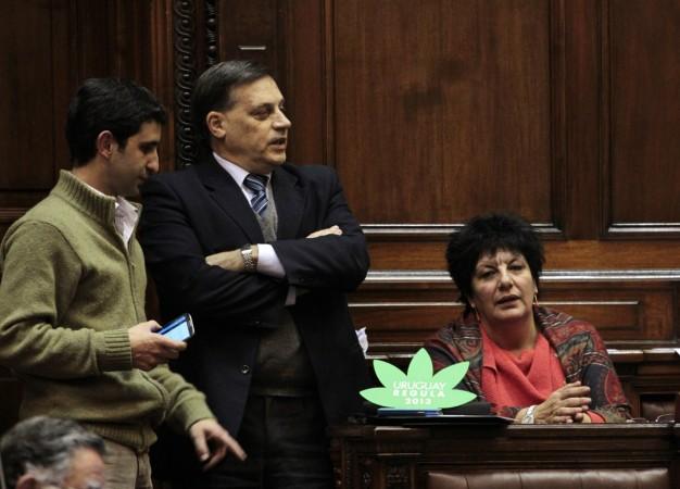 Uruguayan legislators of the ruling Frente Amplio party Daniel Caggiani (L), Carlos Varela (C) and Ivonne Passada participate in a debate before voting on a bill that regulates marijuana growth and sale advances, in Montevideo July 31, 2013. Marijuana Legislature