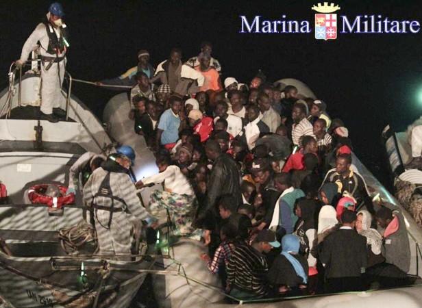 Migrants sit in their boat during a rescue operation by Italian navy ship Scirocco about 40 nautical miles off the coast of Libya in this handout picture released on June 14, 2014 by the Italian Marina Militare. Migrants sit in their boat during a rescue operation by Italian navy ship Scirocco about 40 nautical miles off the coast of Libya in this handout picture released on June 14, 2014 by the Italian Marina Militare.