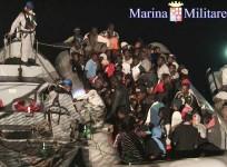 Migrants sit in their boat during a rescue operation by Italian navy ship Scirocco about 40 nautical miles off the coast of Libya in this handout picture released on June 14, 2014 by the Italian Marina Militare.