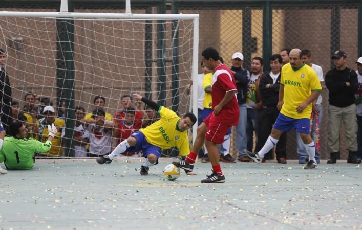Prisoners, wearing Brazil's national soccer team jerseys, play against a team of veteran Peruvian players, who are visitors to the event, at their own version of the 2014 World Cup at the Castro-Castro prison in Lima, June 2, 2014. Prisoners