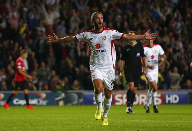 MK Dons forward Will Grigg cannot hide his delight after scoring against Manchester United in the League Cup Will Grigg MK Dons Manchester United